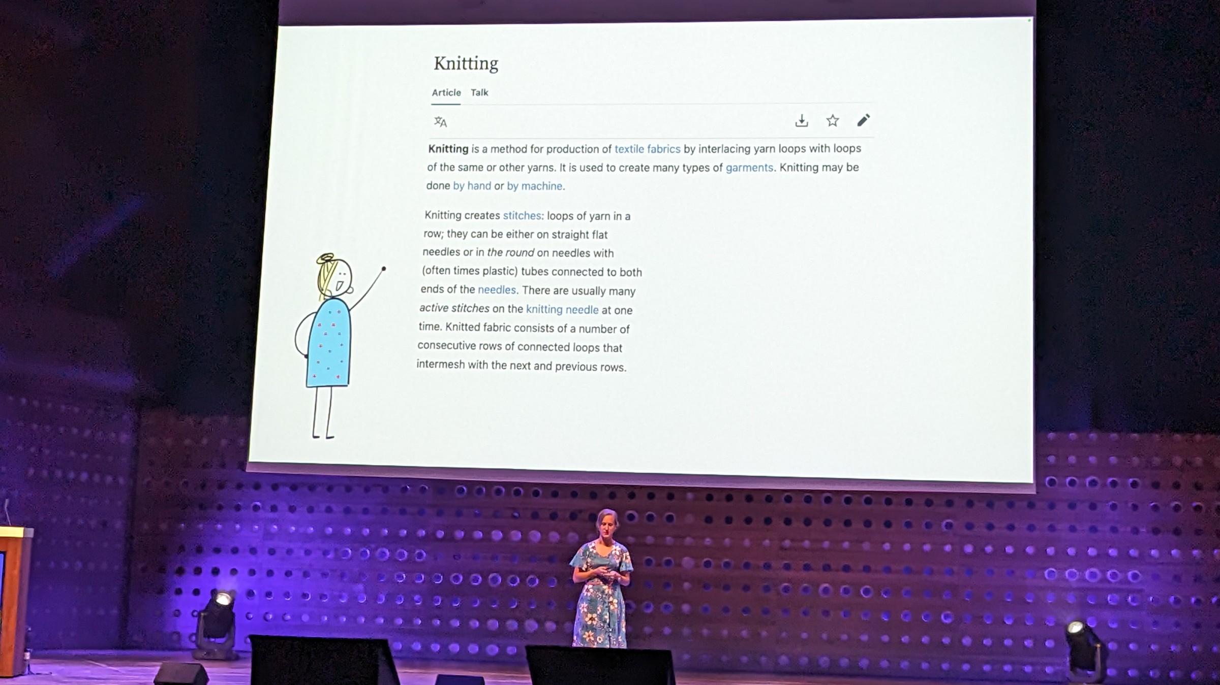 Felienne on stage talking about knitting. The slide shows the wikipedia entry for 'knitting'