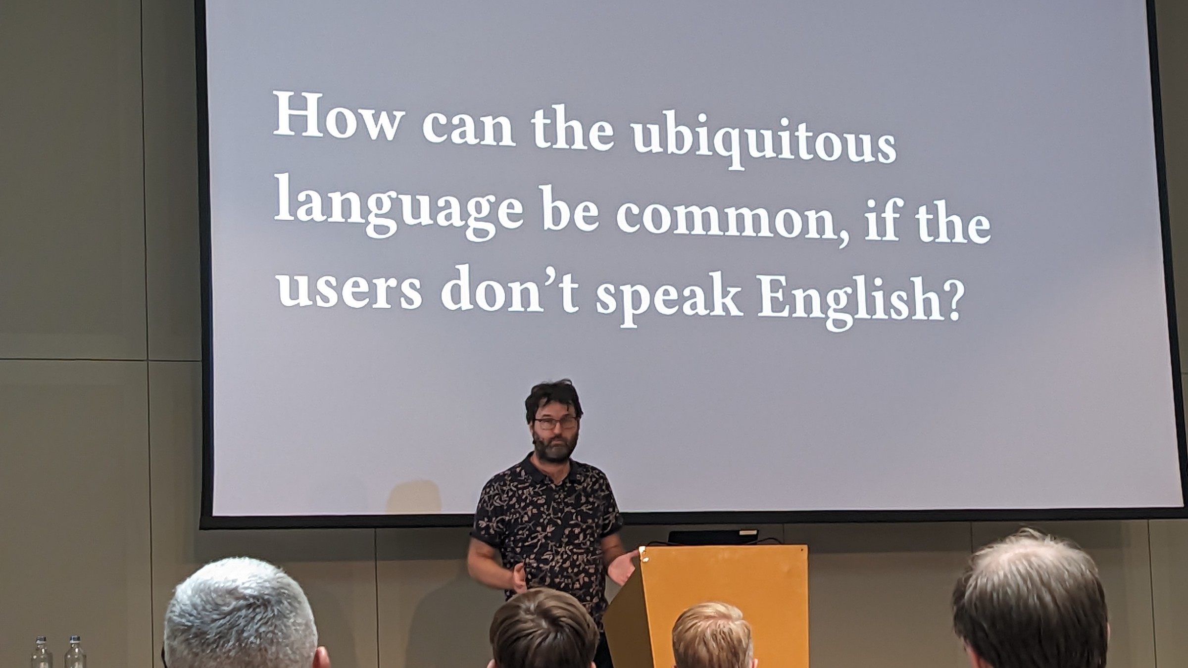 William in front of a slide reading: How can the ubiquitous language be common, if the users don't speak English?